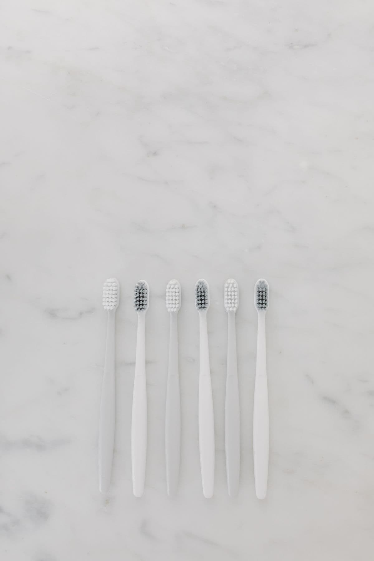 Clean toothbrushes arranged on a bright surface