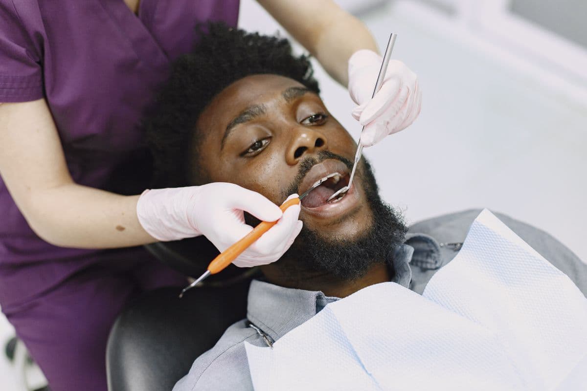 A dentist attending to a patient with calm, focused care